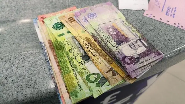 Uang Riyal di atas meja Money charger